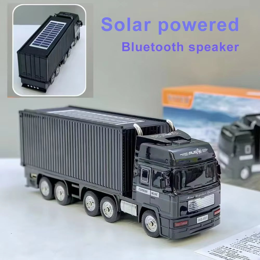 Black semi truck Bluetooth speaker, WSTER WS-691, solar-powered portable wireless audio for desk setup decor.