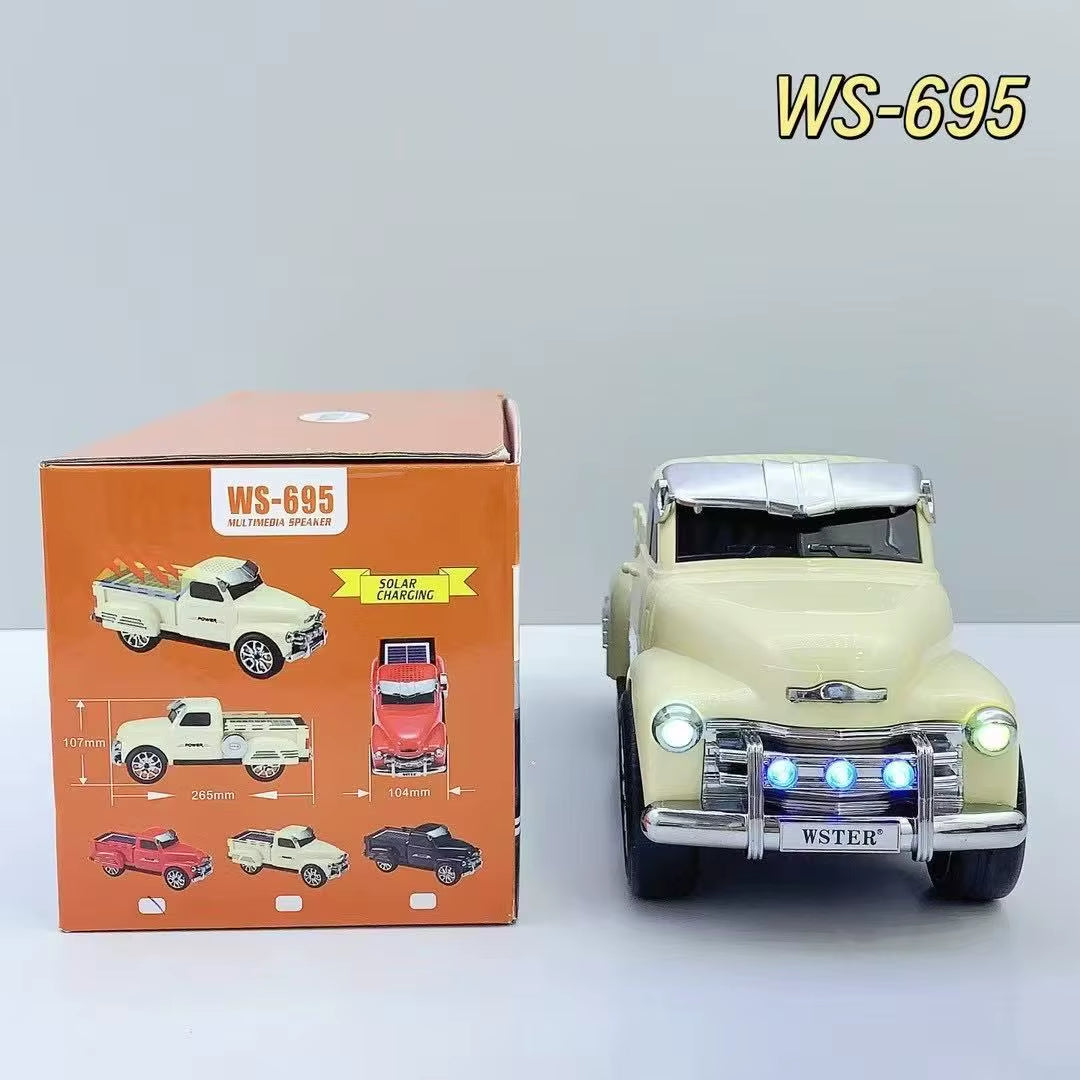 Off-road truck style Bluetooth speaker with solar charging, LED headlights and moving wheels, WSTER WS-695.