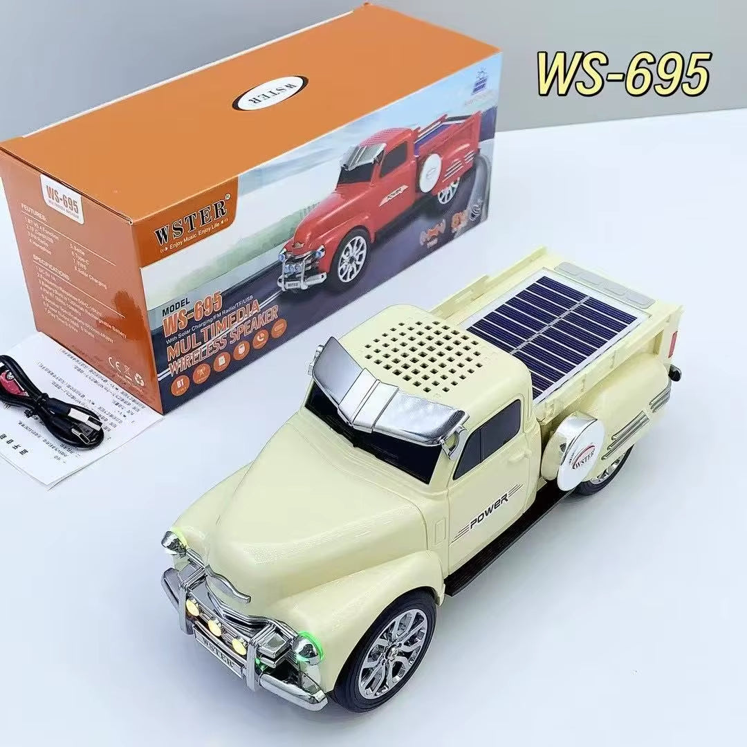 Beige off-road truck Bluetooth speaker with solar charging and LED headlights, WSTER WS-695 desk setup decor.