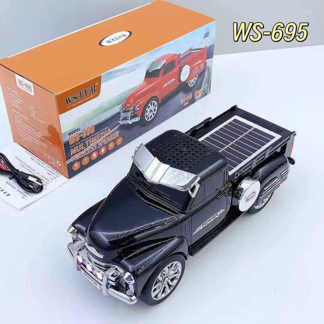 Black off-road truck Bluetooth speaker with solar charging, LED headlights and moving wheels, WSTER WS-695.