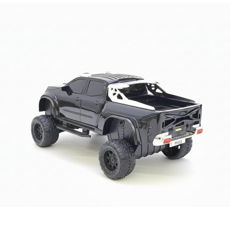 Black monster truck Bluetooth speaker with LED headlights and engine sound, WSTER WS-X65 desk setup accessory.